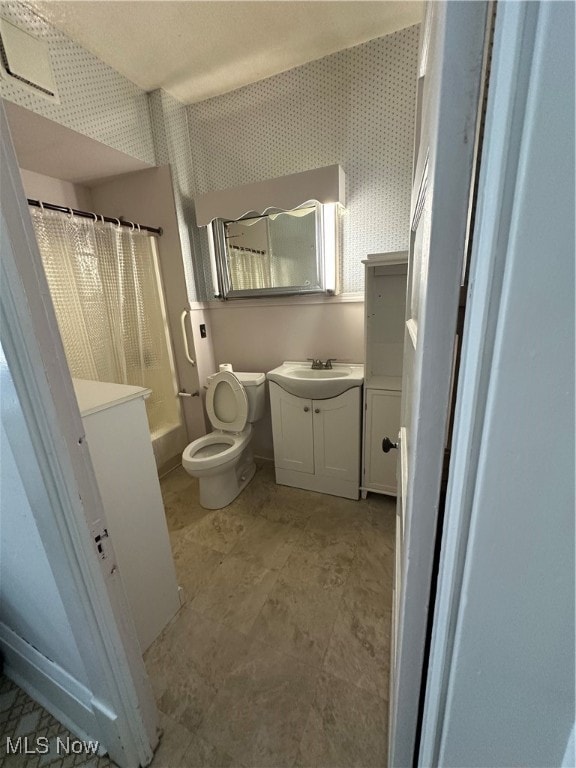 full bathroom featuring vanity, toilet, and shower / bath combo with shower curtain