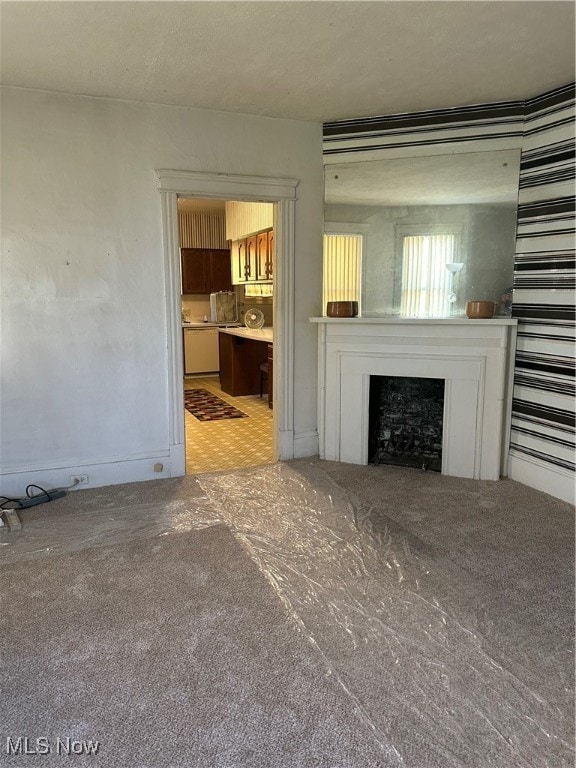 unfurnished living room featuring carpet