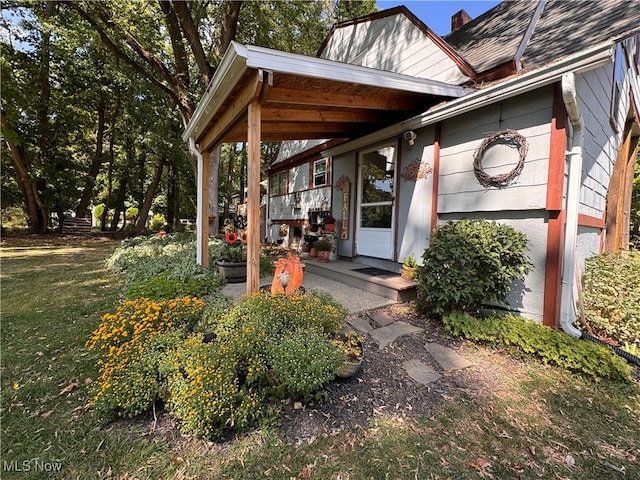 entrance to property with a lawn