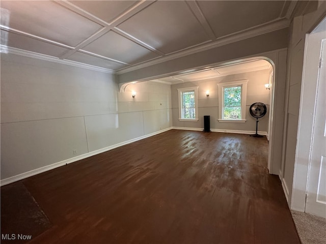 empty room featuring coffered ceiling, crown molding, and dark wood-type flooring