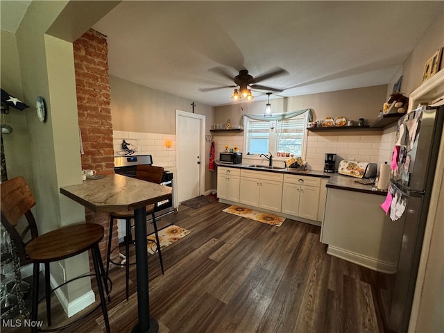 kitchen featuring ceiling fan, sink, dark wood-type flooring, white cabinetry, and appliances with stainless steel finishes