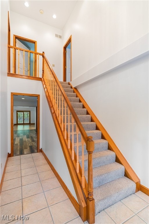 stairway featuring tile patterned flooring