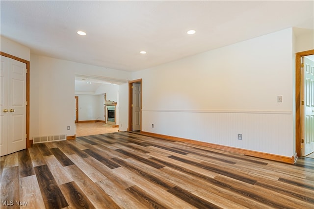 unfurnished room with wood-type flooring