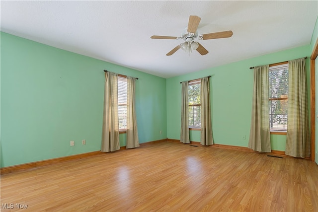 empty room with light wood-type flooring and ceiling fan