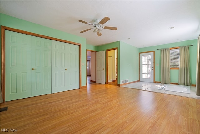 interior space featuring light wood-type flooring and ceiling fan