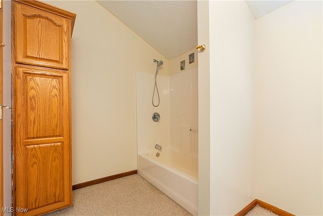 bathroom featuring shower / bathtub combination and lofted ceiling