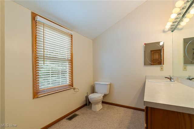 bathroom featuring vaulted ceiling, vanity, and toilet