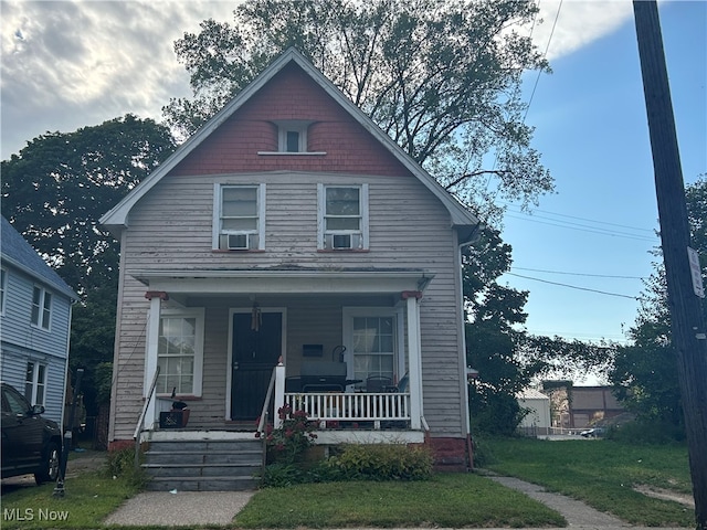 view of front of home with a front lawn and a porch