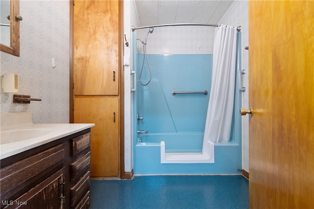 bathroom with vanity, tile walls, and shower / bath combo with shower curtain