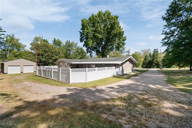 view of side of property featuring an outdoor structure and a garage