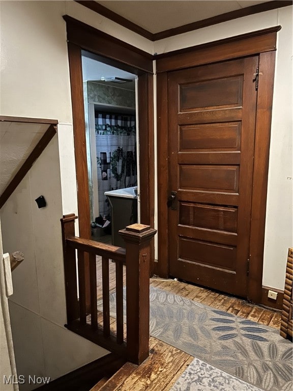 entryway with hardwood / wood-style flooring and ornamental molding