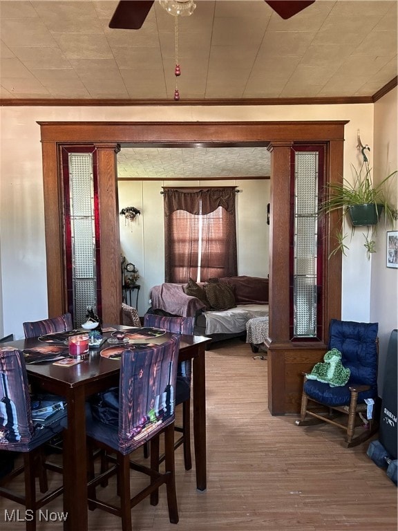 dining space featuring crown molding, ceiling fan, and hardwood / wood-style flooring