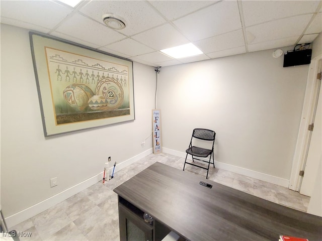 living area featuring a paneled ceiling