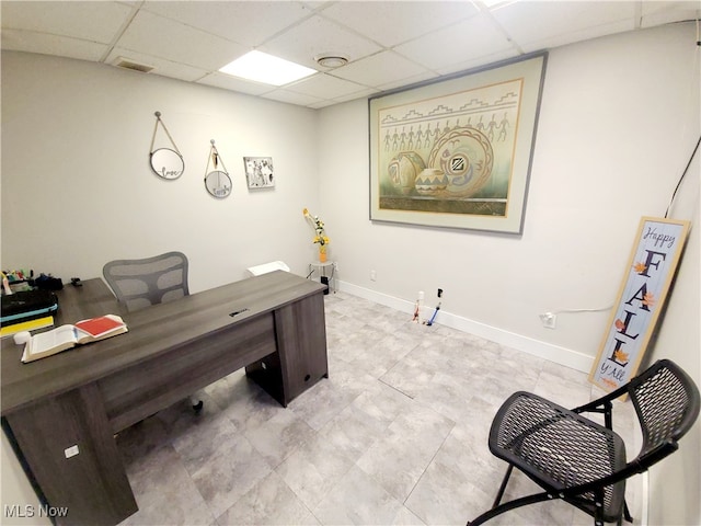 office area with a paneled ceiling