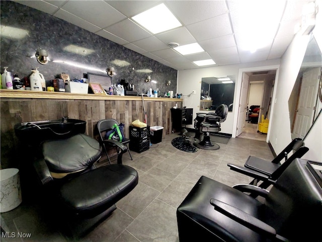 misc room with a drop ceiling and tile patterned floors