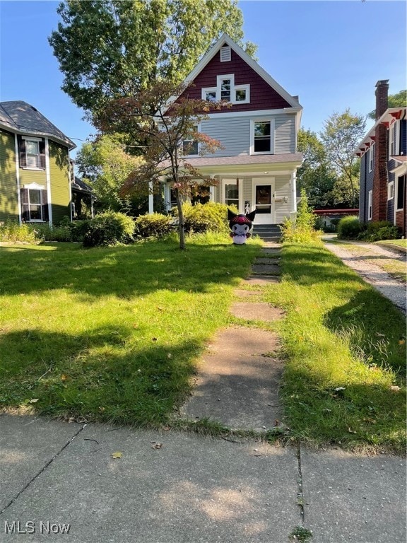 victorian-style house with a front yard