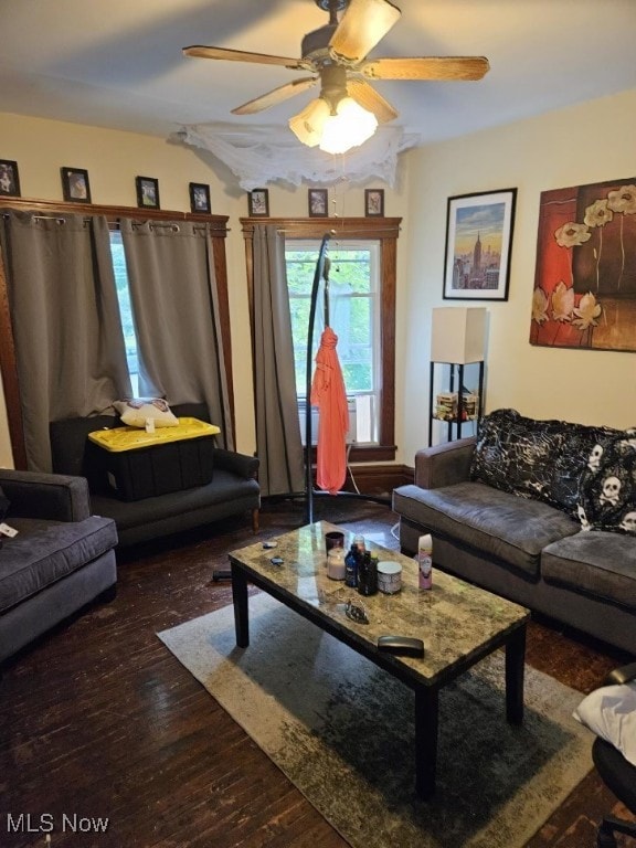 living room featuring dark hardwood / wood-style floors and ceiling fan