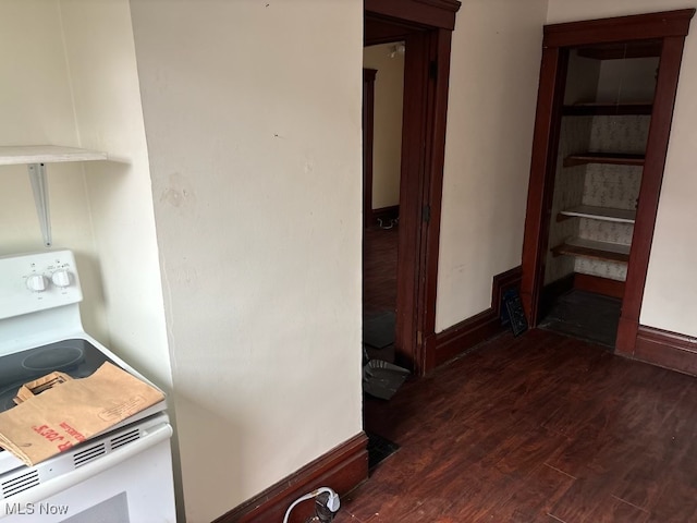 kitchen with white range oven and dark wood-type flooring