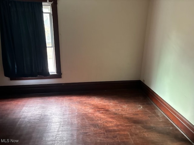 unfurnished room featuring dark wood-type flooring