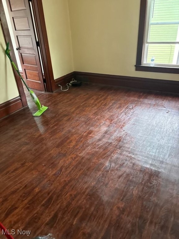 empty room featuring dark hardwood / wood-style flooring