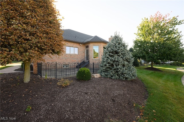 view of side of property featuring a yard