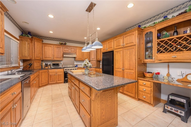 kitchen featuring appliances with stainless steel finishes, hanging light fixtures, light tile patterned floors, and a kitchen island