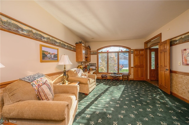 living room featuring dark colored carpet and vaulted ceiling