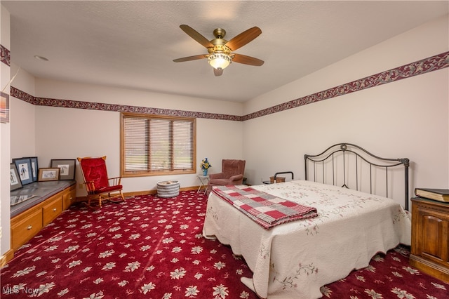 bedroom featuring ceiling fan, a textured ceiling, and carpet flooring