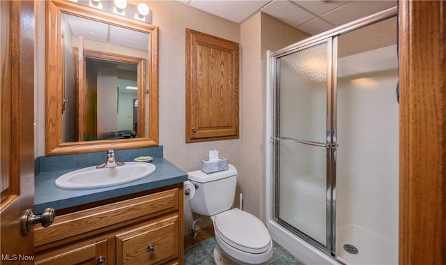 bathroom with walk in shower, vanity, toilet, and tile patterned floors