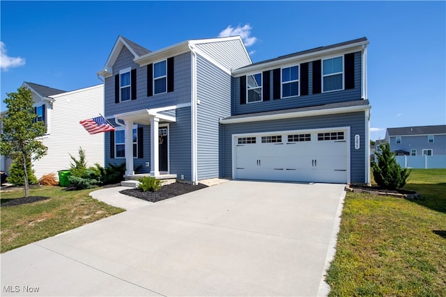 view of front of house featuring a garage and a front lawn