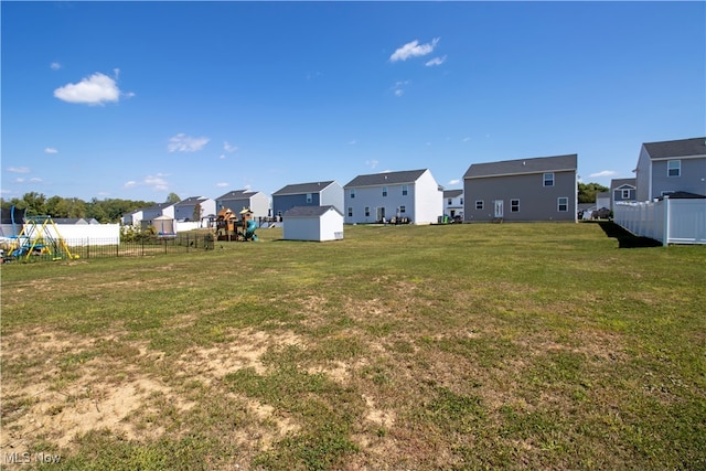 view of yard with a playground and a storage shed