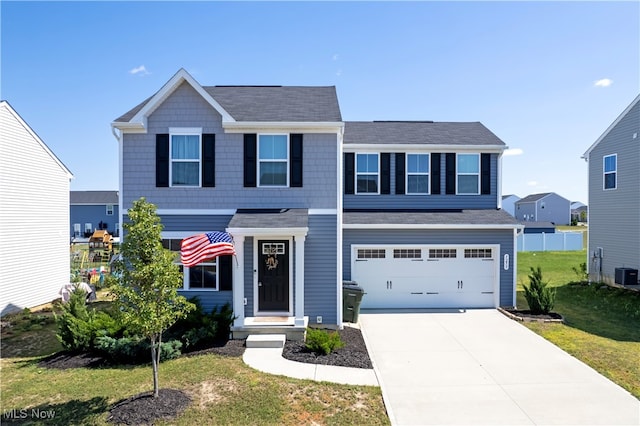 view of front of home featuring a front yard and a garage