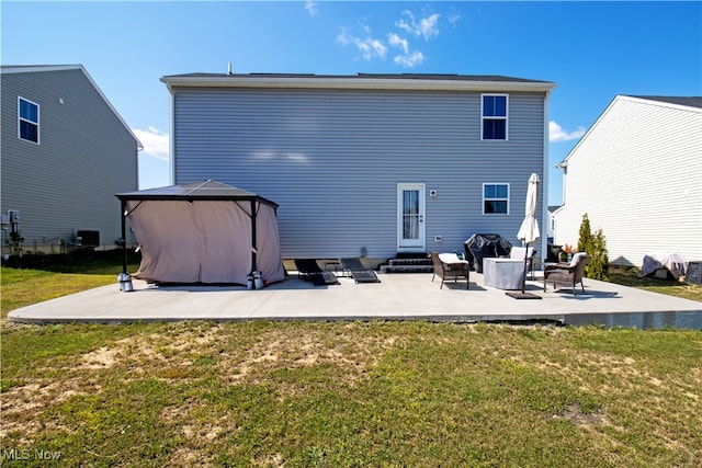 back of property with a patio, a gazebo, and a lawn