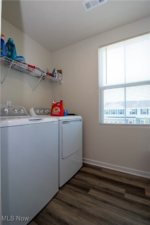 laundry room with washer and clothes dryer and dark hardwood / wood-style flooring