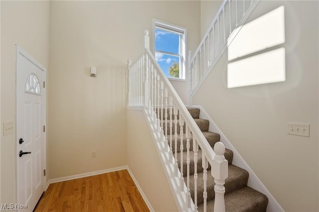 stairway featuring wood-type flooring