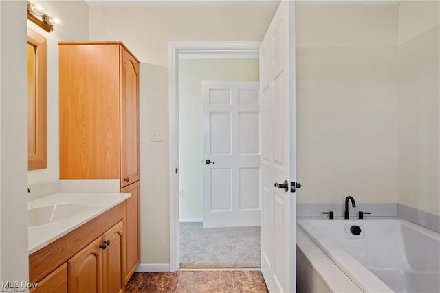 bathroom featuring vanity and a bath