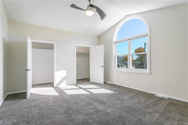 unfurnished bedroom with carpet, vaulted ceiling, and ceiling fan