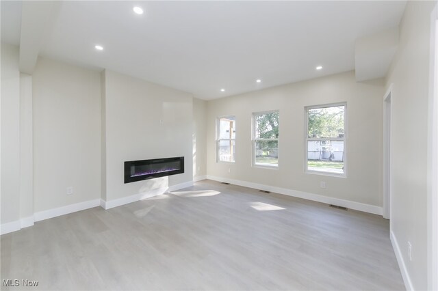 unfurnished living room featuring light hardwood / wood-style flooring