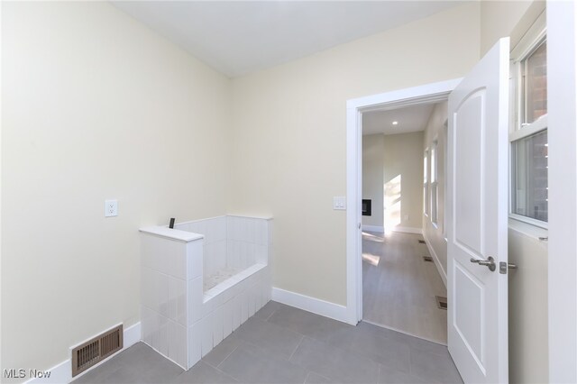 washroom with dark tile patterned floors