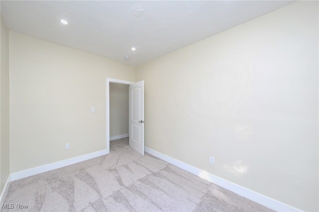 empty room with light colored carpet