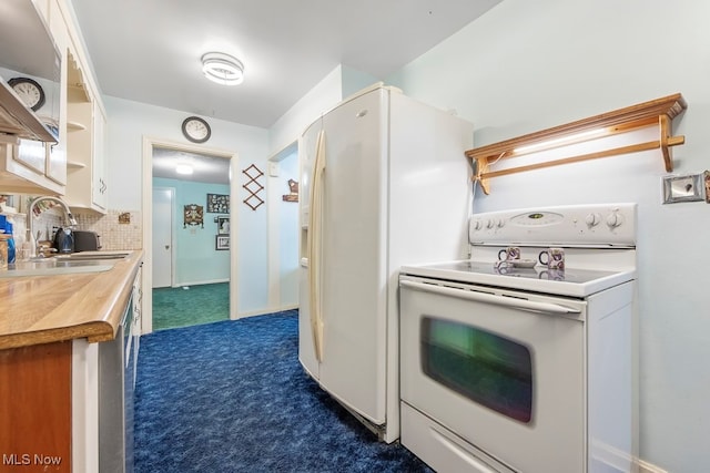 kitchen with backsplash, white appliances, and sink