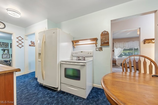 kitchen with dark colored carpet and white appliances