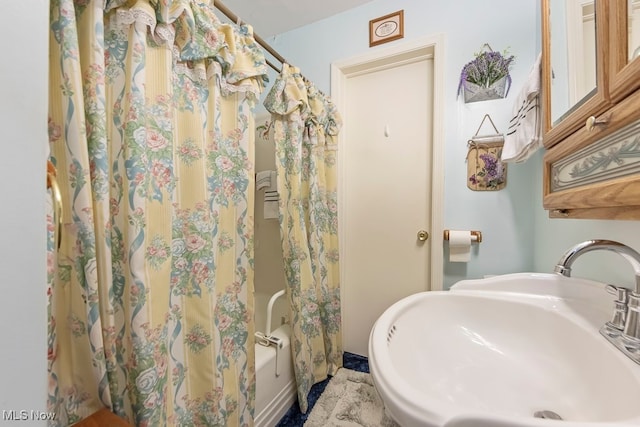 bathroom with sink and a shower with shower curtain