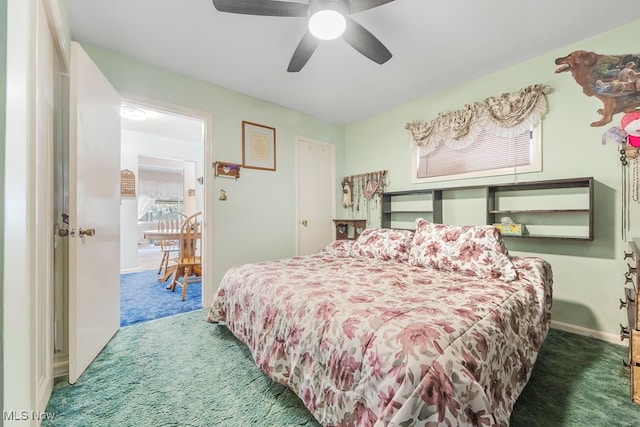 bedroom with ceiling fan and dark carpet