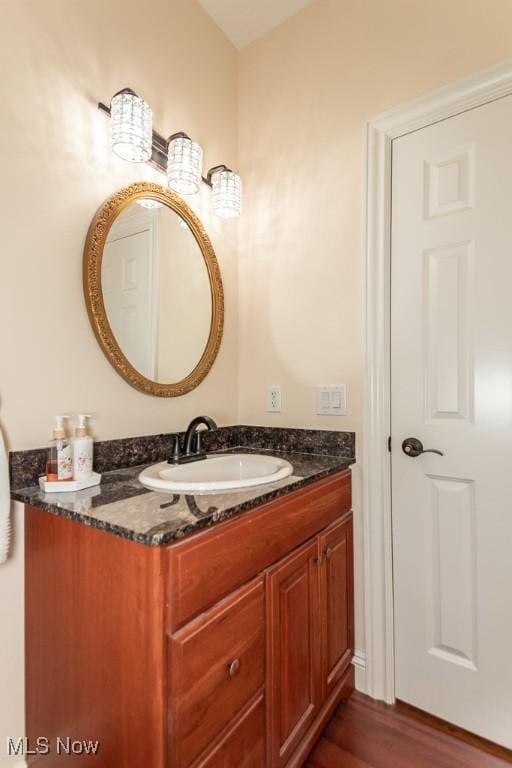 bathroom with vanity and wood finished floors