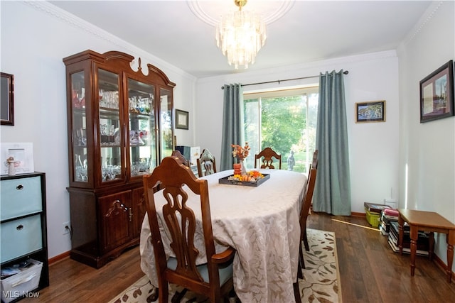 dining room featuring an inviting chandelier, crown molding, and dark hardwood / wood-style flooring