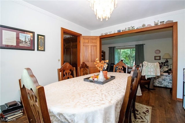 dining area with dark wood-type flooring and crown molding