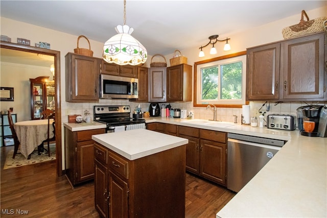 kitchen featuring tasteful backsplash, sink, hanging light fixtures, stainless steel appliances, and dark hardwood / wood-style flooring