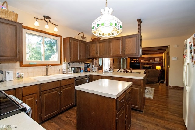 kitchen with pendant lighting, a center island, dark wood-type flooring, sink, and white fridge