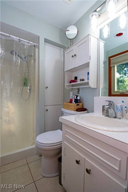 bathroom with walk in shower, tile patterned flooring, vanity, and toilet